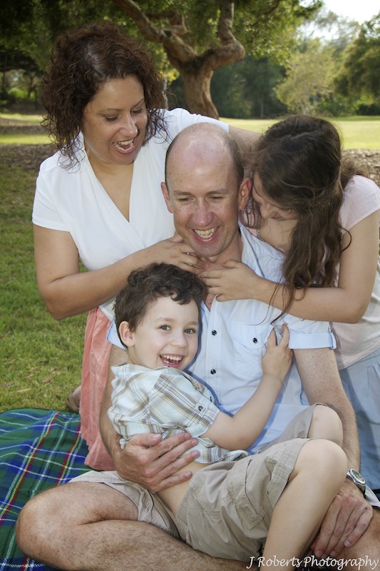 Family tickling father - family portrait photography
